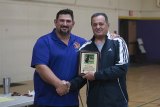 Marcio Botelho accepting a plaque from his Fresno State Wrestling Coach Dennis DeLiddo.